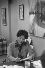 An unidentified woman reads over notes in a VEP office.