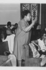 Southern Christian Leadership Conference (SCLC) staff member Rita Samuels in shown speaking at an event during the 23rd Annual SCLC Convention in Cleveland, Ohio. Written on verso: Rita Samuel - Cleveland, '80