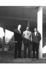 Three male ITC students stand in the breezeway on the ITC campus.