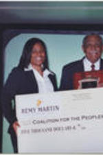 A check for $5,000 is presented to Joseph E. Lowery, Chair of the Georgia Coalition for the Peoples' Agenda, by representatives from Remy Martin.