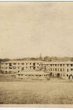 View of the construction of Army barracks on the campus of Atlanta University. Knowles Hall is visible in the background.