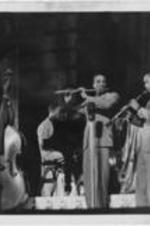 Wayman Carver plays the flute with other unidentified musicians.