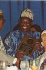 Joseph E. Lowery and Claud Young are shown presenting the International Humanitarian Award to Chief Moshood K. Abiola at the 35th Annual Southern Christian Leadership Conference Convention.