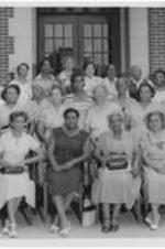 Group of women with Dr. Harry V. Richardson and his wife. Written on verso: Mrs. [Selma] Richardson, president of Methodist women in the central jurisdiction, Georgia. Marie Copher, second from left, first row- white dress.