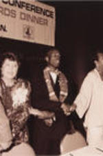 Evelyn G. Lowery is shown holding hands with others, including Maya Angelou (second from right), during the proceedings of the 13th Annual Drum Major For Justice Awards. More details about the awards ceremony can be found on pages 48-51 of the June-July 1992 SCLC Magazine: http://hdl.handle.net/20.500.12322/auc.199:07049.