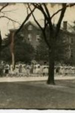 View of students assisting in moving the library in 1928, outside Packard Hall.