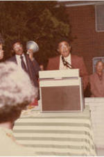 Joseph E. Lowery shown speaking at a podium during an outdoor event.