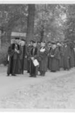 Inauguration participants, including Dr. Harry V. Richardson, walk down the sidewalk. Written on verso: Inauguration of Dr. Harry Richardson 1949.