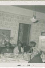 A group of unidentified people eat at a table.