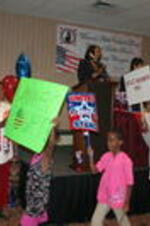 Children march with signs during a forum event focused on the topic of "women's ballot power".