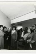 View of people gathered for Dobbs Lounge dedication. Written on verso: The dedication ceremony of the lounge of the Living-Learning Center on February 14, 1985. The lounge was named after singer Mattiwilda Dobbs (c'46). Pictured w/sisters- Josephine, Millicent and Willie Dobbs as well as President Donald Mitchell Stewart. The dedication ceremony for the Marion Anderson Lounge in LLCI. Ms. Sandra Grmyes represented her aunt Marian at the ceremony in 1985. Left to right: Millicent Dobbs Jackson, Sandra Grymes.