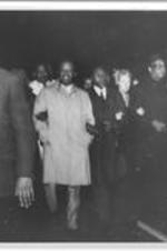 Ralph D. Abernathy is shown marching arm in arm with others.