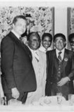 Southern Christian Leadership Conference (SCLC) President Joseph E. Lowery (third from right) poses for a photo with others at the 23rd Annual SCLC Convention in Cleveland, Ohio. Caption from page 20 of the September-October 1980 SCLC Magazine (http://hdl.handle.net/20.500.12322/auc.199:07014): "Some of the illustrious head table guests at the Southern Christian Leadership Conference (SCLC) Annual Board/Staff Luncheon during SCLC's 23rd Annual Convention in Cleveland, Ohio. Pictured left to right: Mr. W.O. Walker, Publisher of The Cleveland Call and Post; guest speaker Dr. Leon Sullivan, founder and president of Opportunities Industrialization Centers of America (OIC); Dr. Ralph D. Abernathy, president emeritus of SCLC; Bishop F.E. Perry of the Southern Ohio Jurisdiction; Dr. Joseph E. Lowery, president of SCLC; Rev. E. Randel T. Osburn, president of the Ohio Chapter of SCLC; and Congressman Walter Fauntroy, Chairman of the Board of SCLC.