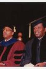 Thomas W. Cole, Jr. and Lou Rawls sit on stage at the summer commencement. Written on verso: CAU Summer Commencement - l to r -Thomas W. Cole, Jr., Lou Rawls, Photographed by 1989 Jim Alexander.