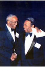 C. Eric Lincoln shakes hands with John Hope Franklin.