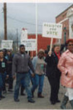 SCLC/W.O.M.E.N. Civil Rights Heritage Tour participants march while holding signs advocating for voting and voter registration.