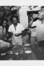 Joseph E. Lowery is shown eating food with other individuals while in Lebanon as part of the Southern Christian Leadership Conference's Mid-East peace mission.