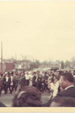 A large group of people walk down the street in Martin Luther King Jr.'s funeral procession.