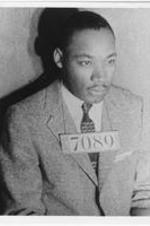 A photo of Martin Luther King, Jr. having his mugshot taken following his arrest during the Montgomery bus boycott.