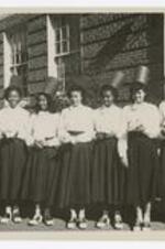 A group portrait of the Alpha Kappa Alpha sorority in front of a building