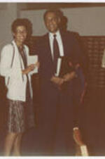 Mr. and Mrs. Clifford Alexander visit special collections. Written on verso: Mr. and Mrs. Clifford Alexander (Mrs. Adele), in Special Collections/Archives Dept., AUC/Woodruff Lib., Mr. Alexander [?]ee�d honorary degree [?]. Summer Commencement, 1982.