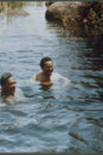 View of Asa Hilliard and two others swimming in the Nile river.