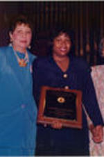 Evelyn G. Lowery is shown presenting an award to the first place contest winner of the SCLC/W.O.M.E.N. Oratorical Contest alongside Rosa Parks and Ingrid Saunders Jones (at left).