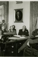 John H. Wheeler gives remarks before Governor Luther H. Hodges (seated at desk) and a group.