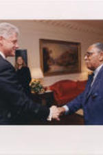Joseph E. Lowery shakes hands with President Bill Clinton in a room at the White House.