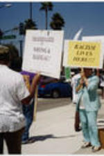 Evelyn G. Lowery and other demonstrators hold protest signs outside of the Creative Artists Agency in Beverly Hills, California.