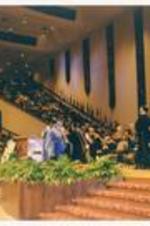 View of stage at Chapel Hill Harvester Church during commencement. Written on verso: Commencement 1999 Chapel Hill Harvester Church; Audrey Manley and Johnnetta Cole.
