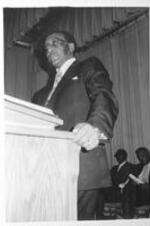 A man speaks from the pulpit.