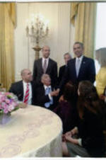 Joseph E. Lowery (sitting, second from left) shakes hands with President Barack Obama in the White House as others look on.