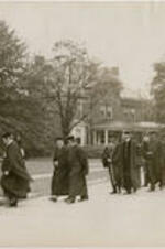 A line of faculty, students, and staff from the Atlanta University Center form a procession before the dedication of the Trevor Arnett Library. Written on verso: Representatives of education foundations, religious societies, and sister colleges in the academic procession to Sisters Chapel on Spelman campus on library dedication day. Exercises were held in this chapel because of rain and threatening weather which made the outdoor service impossible.