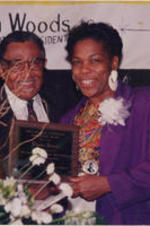 Southern Christian Leadership Conference (SCLC) President Joseph E. Lowery presents attorney Elaine Jones with the Chauncey Eskridge Barrister Award during the awards ceremony at the 34th Annual SCLC Convention in Birmingham, Alabama. Caption from magazine: Attorney Elaine Jones is beaming as she gets the Chauncey Eskridge Barrister Award from Dr. Lowery for her outstanding performance in the legal community. More details about the awards banquet can be found on pages 32-39 of the November-December 1991 SCLC Magazine: http://hdl.handle.net/20.500.12322/auc.199:07045.
