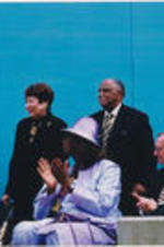 Joseph and Evelyn Lowery receiving applause by a group at an outdoor event.