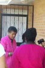 Spelman SIS students wait with Dr. Gloria Gayles outside of Darlene Clark's home.