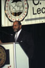 William C. Turner Jr. presents his lecture behind a podium.