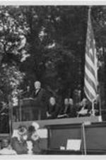 An unidentified man speaks from a podium. Written on verso: Inauguration of Dr. Harry Richardson 1949.