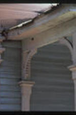 Close up view of the detailin gon a vitorian cottage porch.  Text from slide presentation: Another defining feature of the Victorian cottage is flat or jigsaw cut detailing along the porches ...