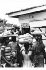 People shop at a market for goods.