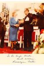 President Hugh Gloster with First Lady, Rosalynn Carter on stage. Written on recto: To Dr. Hugh Gloster, Best Wishes. Rosalynn Carter.