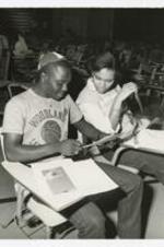 Written on verso: "Two Freshman discusses registration procedures. Morris Brown Clg. 1984-85; Candace Fields + Vincent Ross".