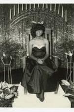 Indoor portrait of a woman seated in an arm chair. Written on verso: "Miss Sonya Hudson- Miss MBC 1983-88".