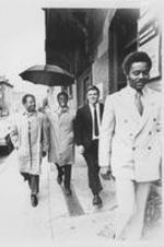 Ralph D. Abernathy is shown walking with a group of men down the street.