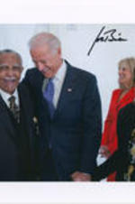 Joseph  E. Lowery is seen laughing with U.S. Vice President Joe Biden while Evelyn G. Lowery looks on. The photo is signed by Joe Biden.