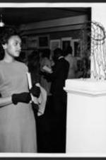 An unidentified woman admires artwork at the 16th annual art exhibition.