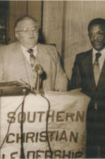 Fred Shuttlesworth stands next to Birmingham Mayor David Vann at an event. Written on verso: Lowery, Vann, Shuttlesworth