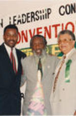 An unidentified man, Dick Gregory, and Claud Young are shown posing for a picture at the 36th Annual Southern Christian Leadership Conference Convention.