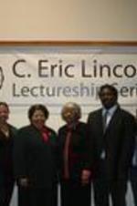 Lucy Lincoln stands with participants of the lecture series.